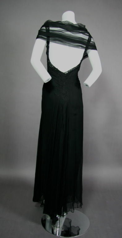 Black Silk Chiffon 1930s full length gown with train. Lace appliqué around neckline and straps moving down into a low back and continuing to the backside, attached train separate from skirt all the way down the back to the floor. Radiating pin tuck