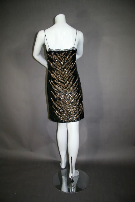 Black Sequined cocktail dress with spaghetti straps and lace trim slip with detail showing at hem and neckline.  <br />
<br />
DRESS MEASUREMENTS<br />
– Bust – 32” <br />
- Waist – 31”<br />
- Hip – 34”<br />
- length from neckline to hem –