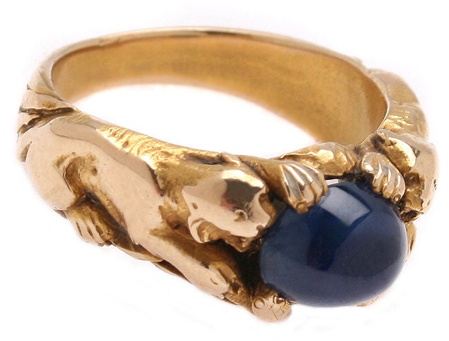 This is a very unusual ring that could be worn by a man or woman.  The cabochon sapphire that is held by a tiger on each side is almost 4 cts. It is a size 9