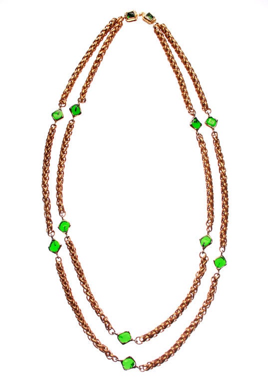 This gorgeous CHANEL necklace features squares of poured green glass and an unusual link with a warm golden color. 