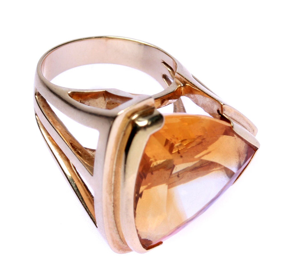 This is a large ring with a faceted topaz that is in an interesting setting.  Looks great on. The ring has a ring size of 10 1/4.