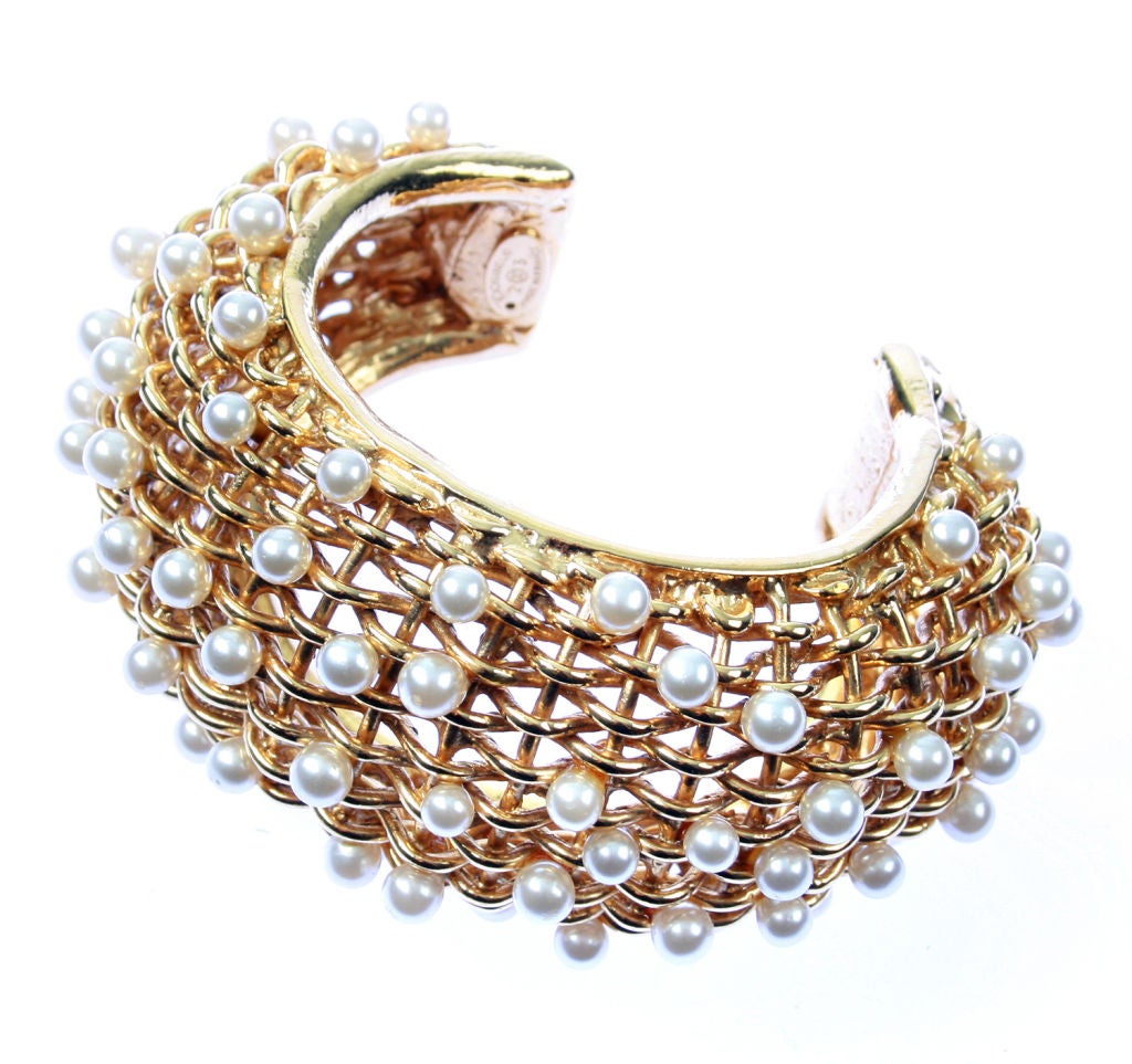 This is a beautiful woven cuff highlighted with faux pearls.  Marked CHANEL 2CC3. It measures 7-1/2