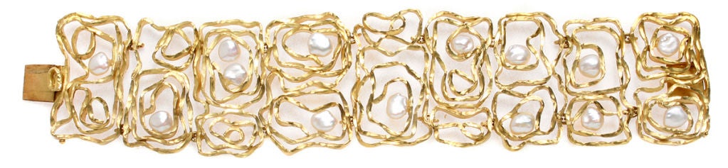 This is a wonderful statement making bracelet. Organic gold links are accented by pearls.  .