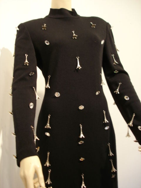 Black knit mock neck fitted cocktail with metal Eiffel tower charms and crystal buttons.