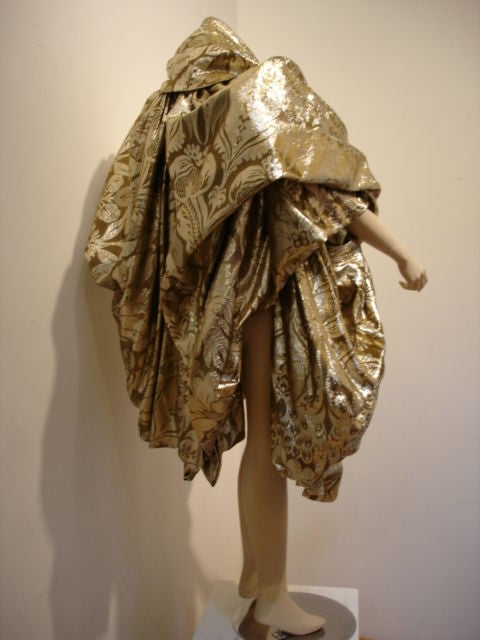 Brocade in a floral motif exaggerated gold lamé stole with high collar.