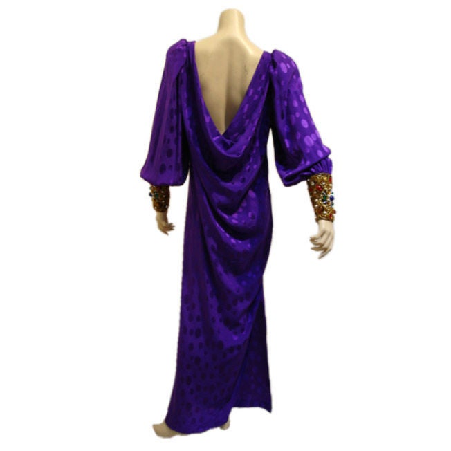 Purple silk crepe de chine cowl back gown with dolman sleeves and heavily jeweled encrusted cuffs.
