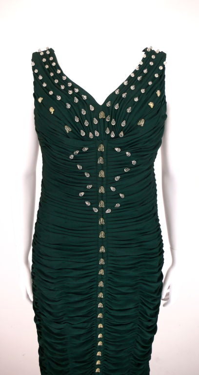 This mermaid forrest green dress is ruched throughout. It has been manufactured by hand with precise detailing. It features clear lucite teardrop beads sewn down the body and a net bottom.