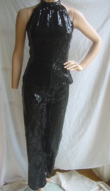 Sexy Vintage Sequin Halter Top and Pant Suit from HALSTON<br />
<br />
This gorgeous pant suit is made of what feels like silk organza in a wonderful shade of black and completely covered with black sequins. The top is a halter top that zips all