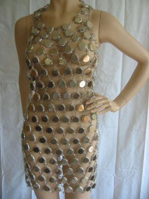 Fabulous Paco Rabanne Style Metal Link Dress<br />
<br />
This fabulous dress is made of silver metal bottle caps that are linked together to create this wonderful dress. The caps at the very top of the neckline are filled with wax to eliminate