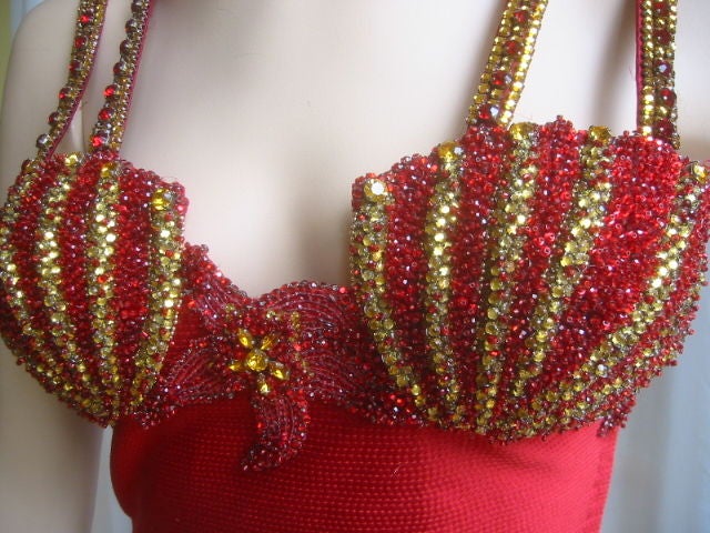 Sexy Iconic Jeweled Vintage Bustier from Gianni Versace 1992 Miami Collection.<br />
This gorgeous bustier is made of what feels like silk in a wonderful shade of red. Designed with a body hugging fit and a cropped length exposing the midriff.