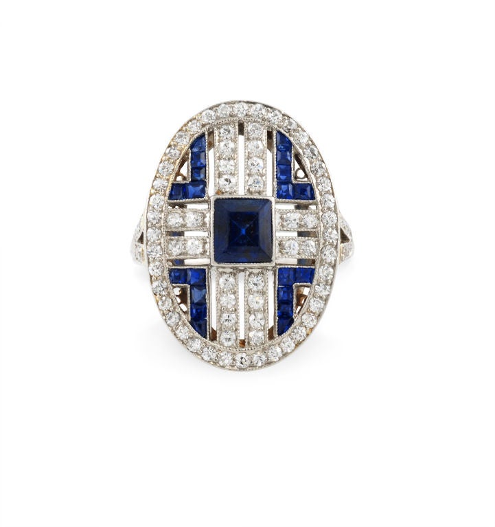 An Art Deco sapphire and diamond ring of pierced oval design, with open diamond-set shoulders, in platinum.  Tiffany & Co.  Atw sapphires 1.86 cts., atw diamonds 0.78 ct.