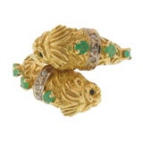 18K gold  lion head ring inset with diamonds and emeralds.
