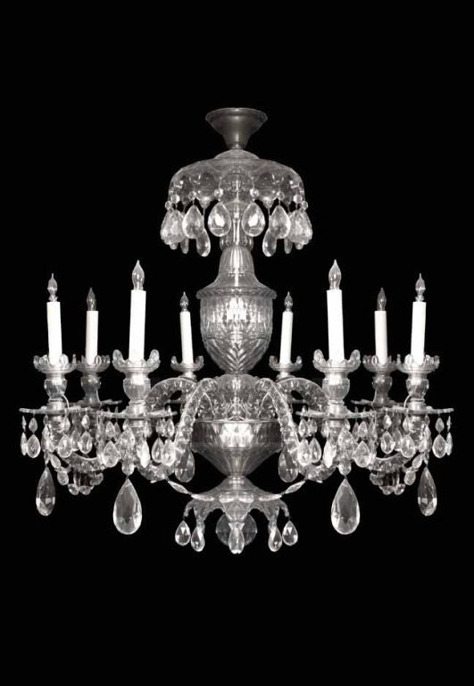 Fine Georgian cut crystal eight light chandelier with excellent cut crystal decoration and beautiful, well balanced, proportions. The central urn shaped shaft surmounted by a notched corona hung with drops and supporting 8 scroll form arms with cut