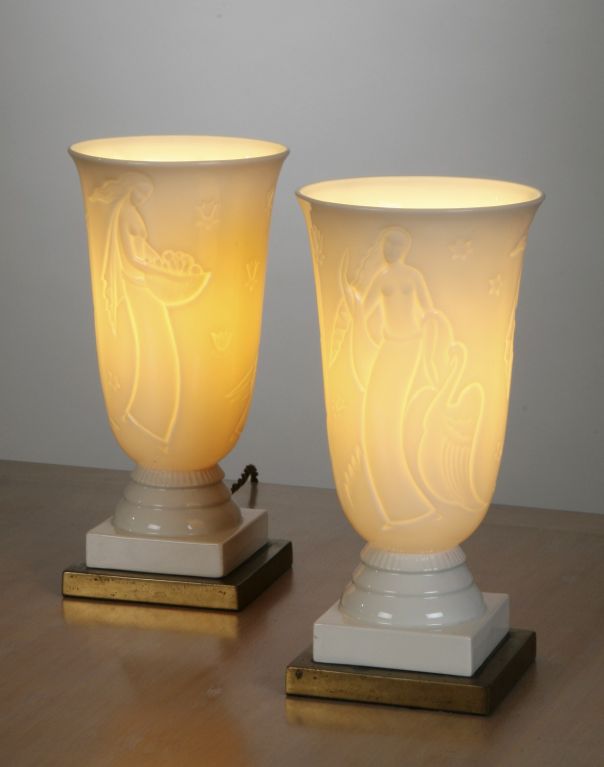 Pair of urn-shaped porcelain lamps on brass bases with incised decoration from Greek mythology, including Leda and the Swan, and Persephone.
