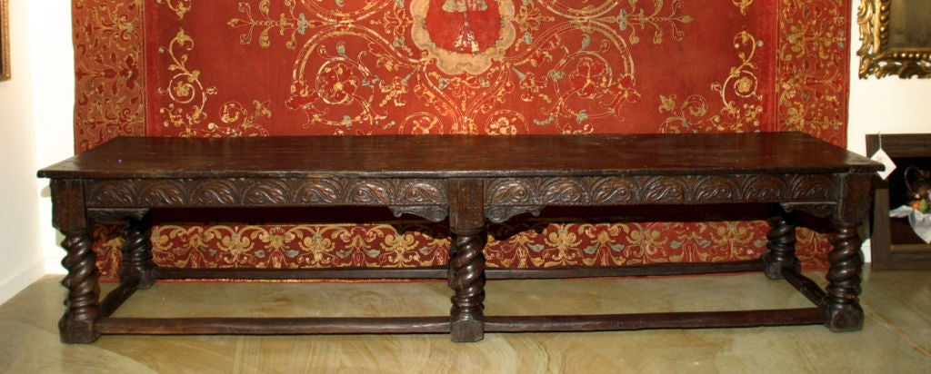 A joined long oak table.  The six-legged joined by strechers with carved decoration throughout the frieze.
