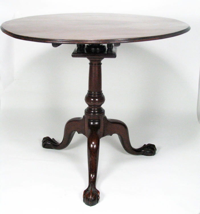 A SPECIMEN vividly grained Santo Domingo mahogany Philadelphia Chippendale tilt-top tea table with RARE moulded top edge, suppressed pedestal ball, suppressed ball and claw feet; and its original complete 'birdcage' to permit swiveling.  Even the