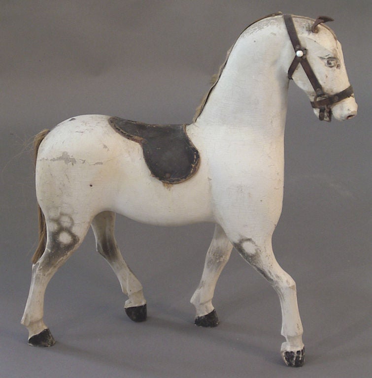 Carved white horse, Denmark circa 1850, with sisal tail and black leather saddle.