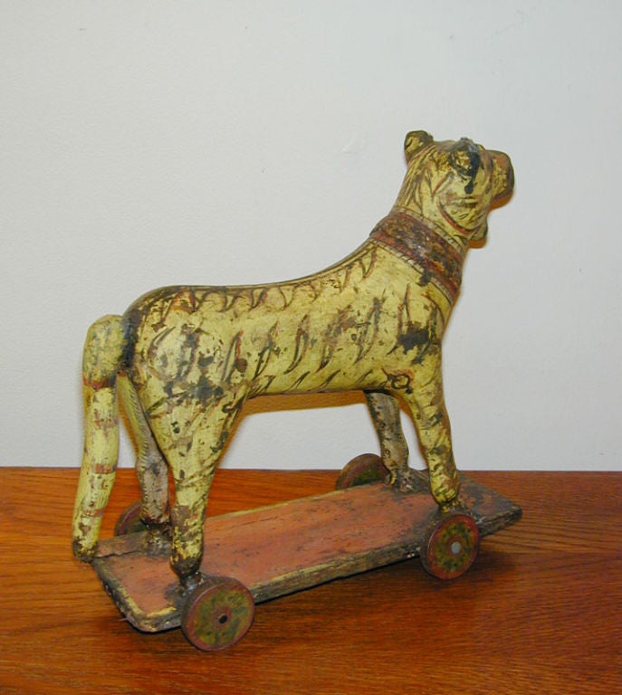19th century Anglo Indian papier mache and painted wood pull toy, a striped yellow tiger on wheels.