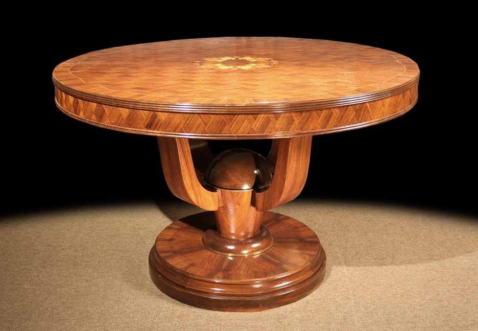 Decorative French palisander gueridon embellished with superbly crafted parquetry work on the round top centering a floral marquetry design. The ribbed molded top edge above a frieze with further parquetry work and all raised on a stylized pedestal