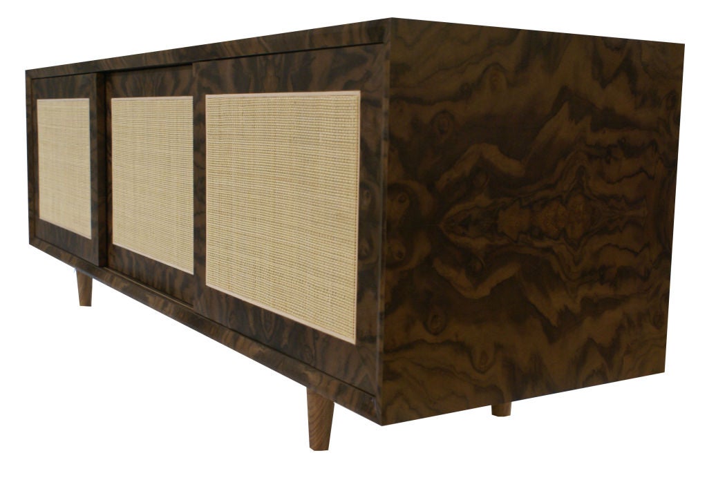 Mn Originals exotic walnut burl veneer cabinet with natural woven caned sliding doors on solid hand turned walnut legs. Custom designed and fabricated through modern living supplies to order.

Custom orders have a lead time of 10-12 weeks FOB NYC.
