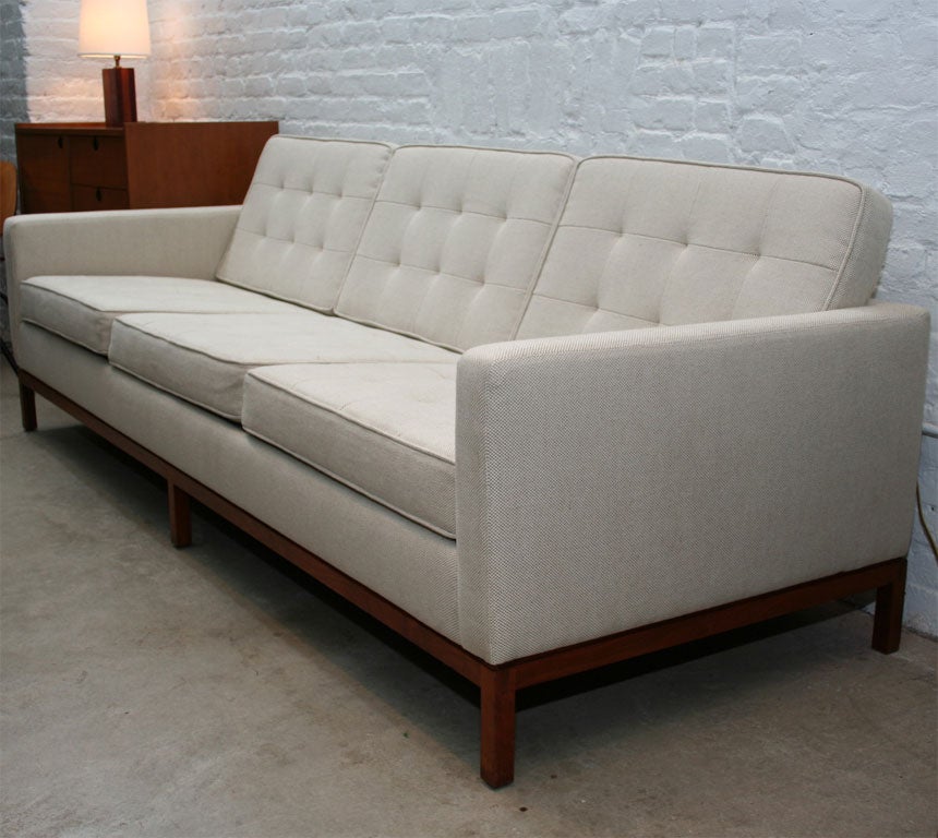 Florence Knoll 3 seat quilted sofa with solid walnut base. Pair of matching chairs available separately.  Set has been redone in a soft off-white linen fabric.