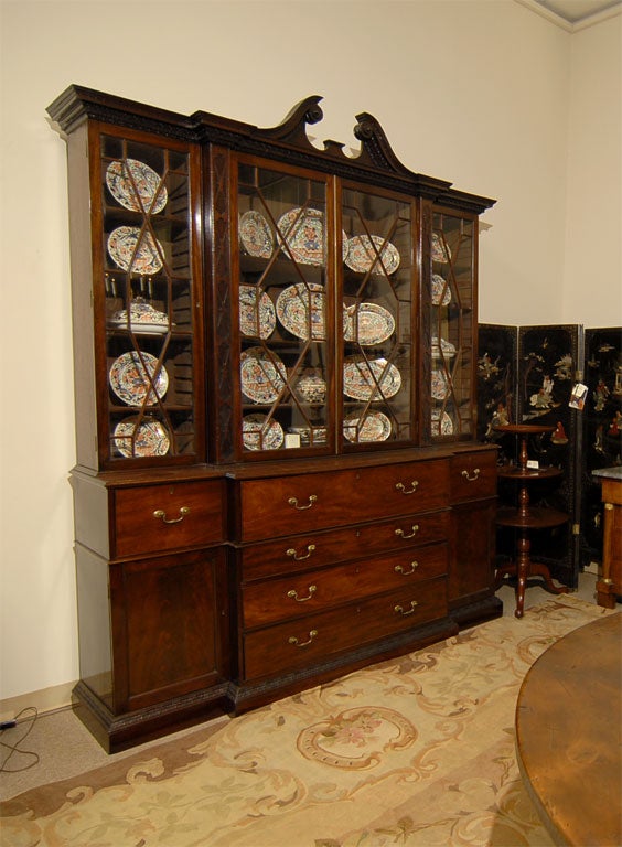 An impressive George III period Breakfront Bookcase with Secretaire drawer, English in origin, and dating from the fourth quarter of the 1700s. <br />
<br />
Standing slightly over 9 ft. high, and featuring a particularly  fine swan-neck pediment
