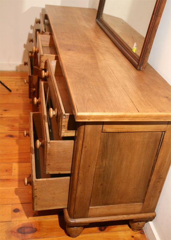 This triple pine dresser base will hold a good part of your wardrobe. Six drawers on each side and in the center is one small drawer with a cubby which has turned columns on each side it 6