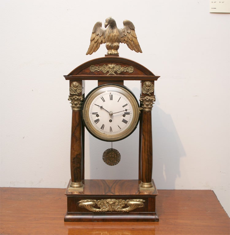 Austrian neoclassical walnut mantel clock with a gilded wood eagle finial, round dial with a 30 hour movement.