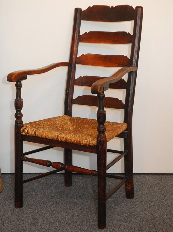 THIS RARE NEW ENGLAND LADDERBACK CHAIR WITH THE ORIGINAL HAND TIED RUSH SEAT IS MADE OF HICKORY WOOD AND IS ALL HAND CARVED AND HAND TURNED WOOD. THE CHAIR IS FROM A PRIVATE COLLECTION AND IS IN GREAT CONDITION.