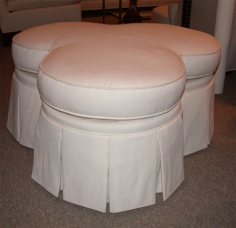 Wonderful and unique clover leaf shaped ottoman with pleated skirt. Great for seating or as a coffee table.