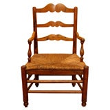 Antique French fruitwood armchair with rush seat.