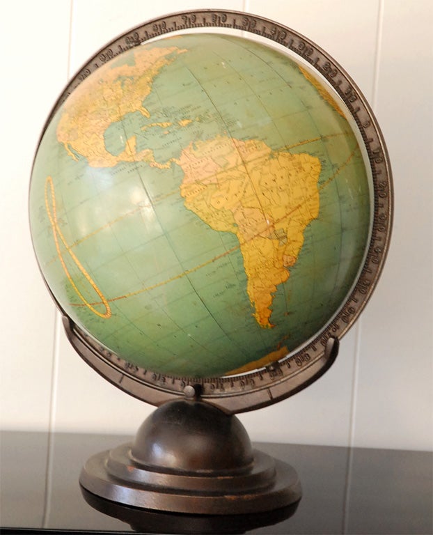 A wonderful Art Deco globe on a bronzed color metal stand. Made by George F Cram Company, USA. This vintage globe has a degree calibrations on the metal ring around the globe and the tilt can be adjusted by loosening a screw between the globe and