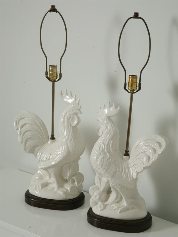 Large pair of white glazed ceramic rooster lamps.