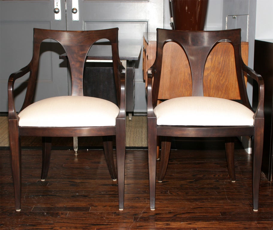 Set of six dark mahogany chairs upholstered in natural linen, two with arms.