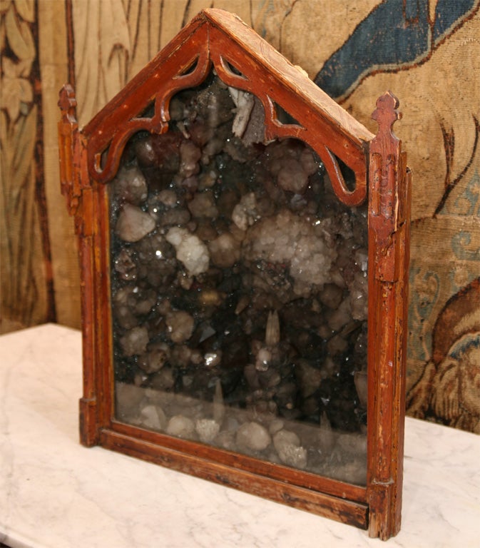 Most unusual crystal and mineral grotto shrine in original grain painted gothic case, with sliding door front enclosing specimen stone interior.