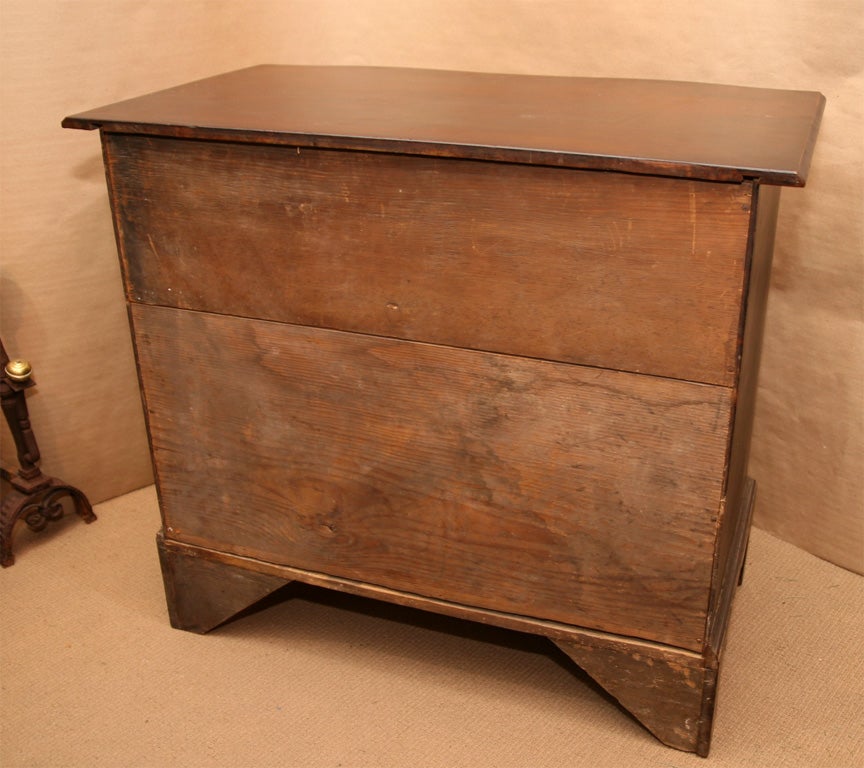 18th Century New England oxbow fronted chest of four drawers, the ogee molded top with dovetailed cleat joinery over four shaped drawers having original hardware, standing on shaped bracket feet, retaining old, possibly original, finish mostly