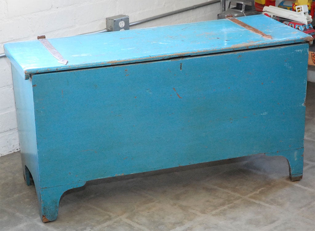Painted in a sky blue this chest has seen a lot in its life and shows signs of having been well used but still cared for. Standing on bracket feet and closing with a strap hinged lid the chest has considerable storage room along with a interior