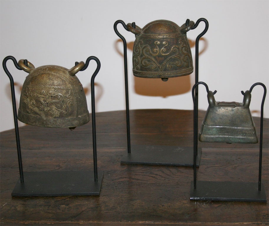 A set of square shaped Cow Bells on stands.