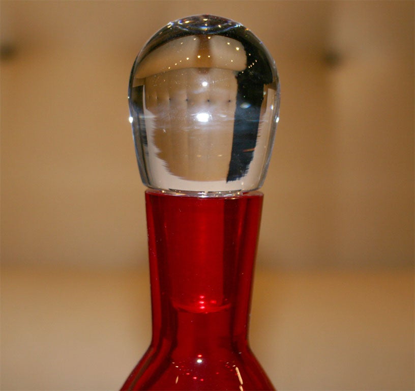 Beautiful hand blown red decanter with clear solid lead top. This decanter has 