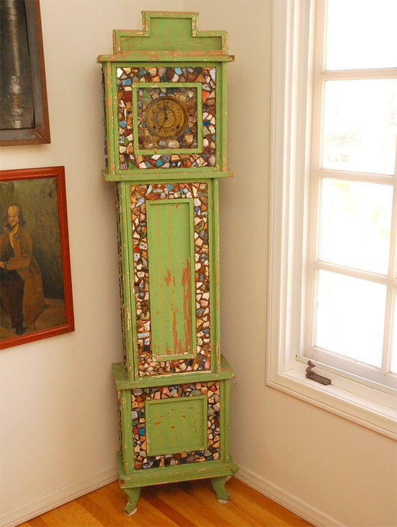 This c. 1920 broken pottery grandfather clock is definitely one of a kind. Considered 