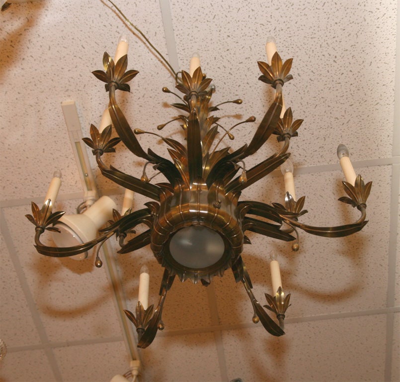 TWELVE LIGHT ANTIQUED BRASS FIXTURE IN LEAF DESIGN