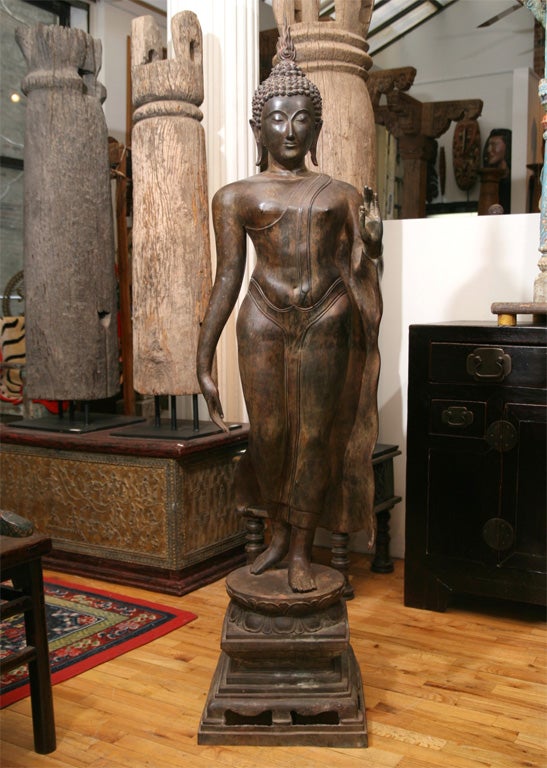 Bronze cast Walking Buddha displaying gesture of knowledge (Vitarka Mudra).