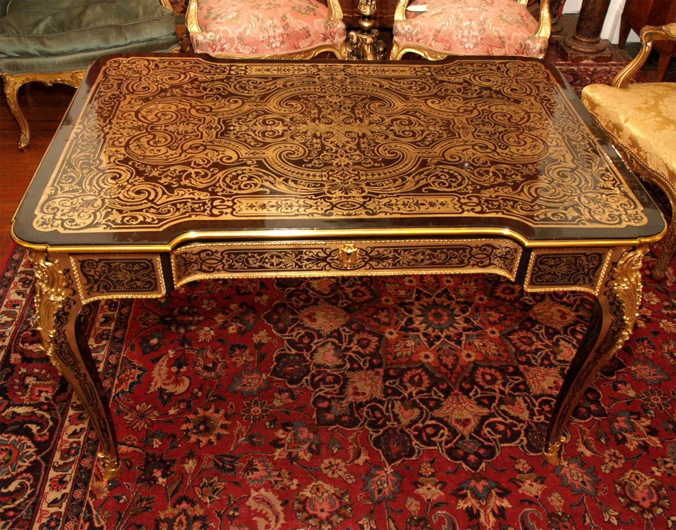 French Napoleon III Boulle Bureau Plat with ormolu mounts and ebony inlaid brass. Exceptional condition. One drawer. Decorated in the round.