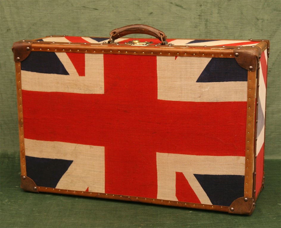 1930's English Suitcase, Newly Covered in Vintage Union Jack Flags with Reinforced Leather-Bound Corners and Strapping with Brass Nail Heads.  England, c. 1930<br />
<br />
<br />
28 inches wide x 18 inches deep x 10 inches high