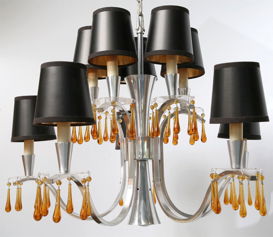 REDUCED FROM $1,500.....Stunning Hollywood Regency Modern ten-light Feldman chandelier in polished shaped and curved aluminium with Lucite bobeches and amber Murano teardrop crystals. Unique design has bottom centre reflector light straight down to