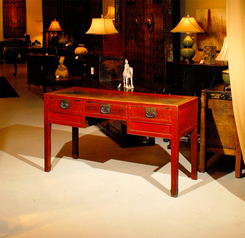This gorgeous red lacquered desk would have most likely been used as a medical practioner's desk.  Locks adorn the hardware.  The drawers were used for strong writing materials.