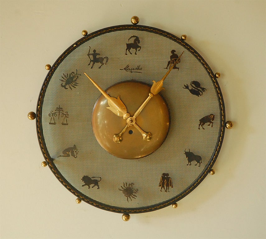 Mauthe iron zodiac wall clock with brass features.