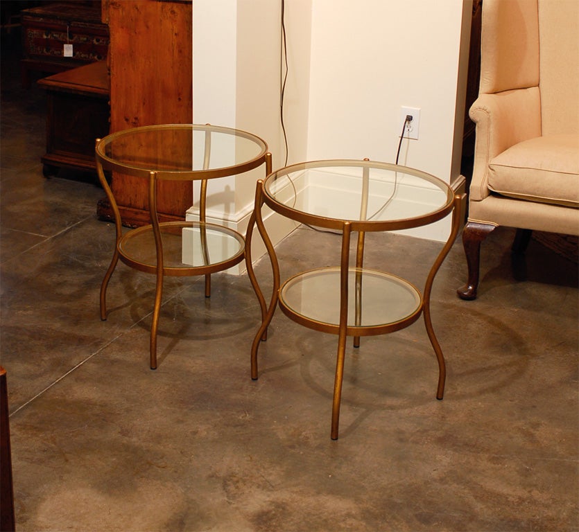 Pair of English gilt round glass top tables