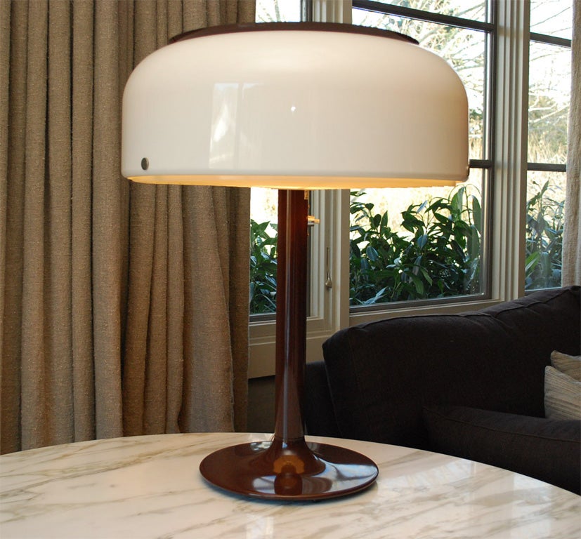 A Swedish modern lamp in chocolate brown and cream molded plastic with a diffuser which is also cream. Base measures 12