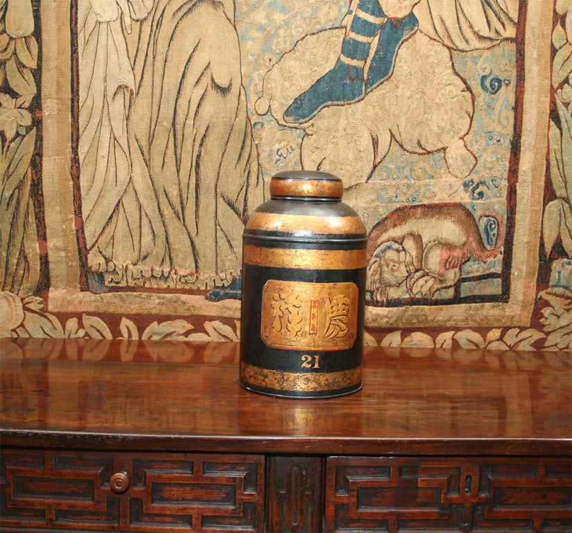 A 19th century English shop display tole tea canister with original black and gold decoration in the chinoisserie style.  Now wonderful for decoration or conversion to lamp.